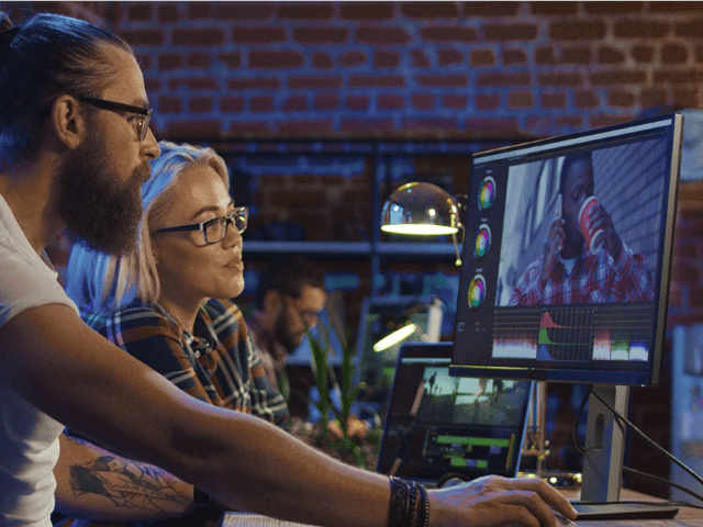 two creative professionals reviewing footage on the cloud