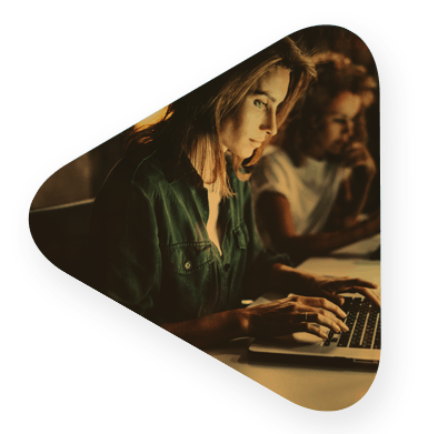 two women typing on their computers