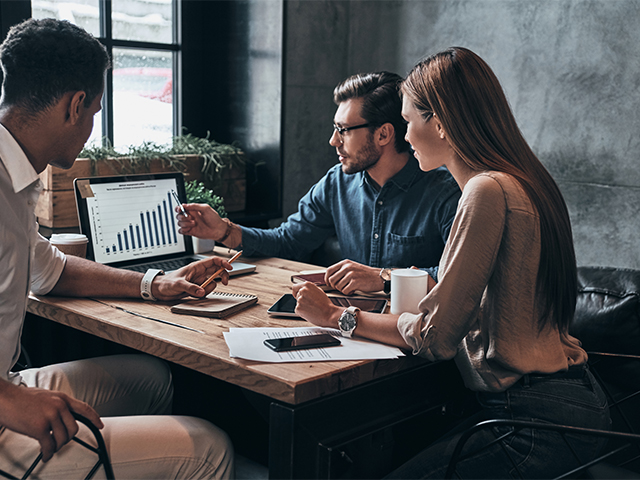 three young professionals review scalable data through cloud dashboards