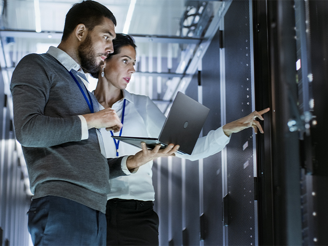 two young professionals reviewing data dashboards