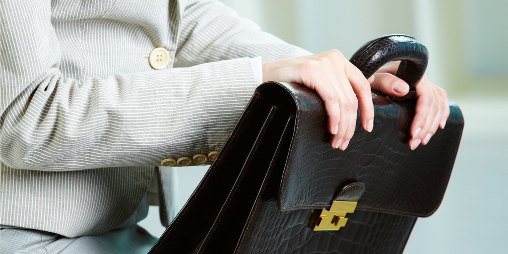 a woman brings a briefcase to an interview in the 2000s