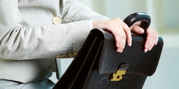 a woman brings a briefcase to an interview in the 2000s