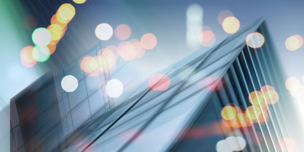 a blurred image of a building in the city with lights