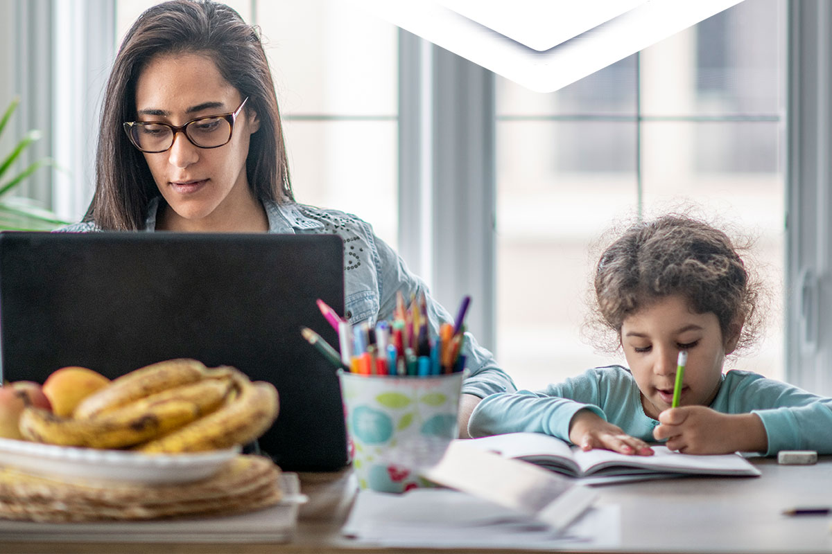 mom working from home while taking care of daughter