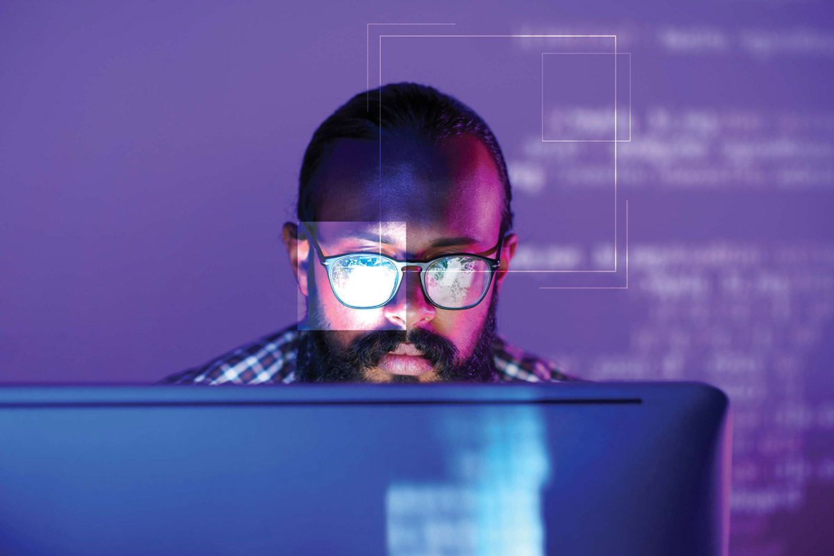 man looking at secure computer code