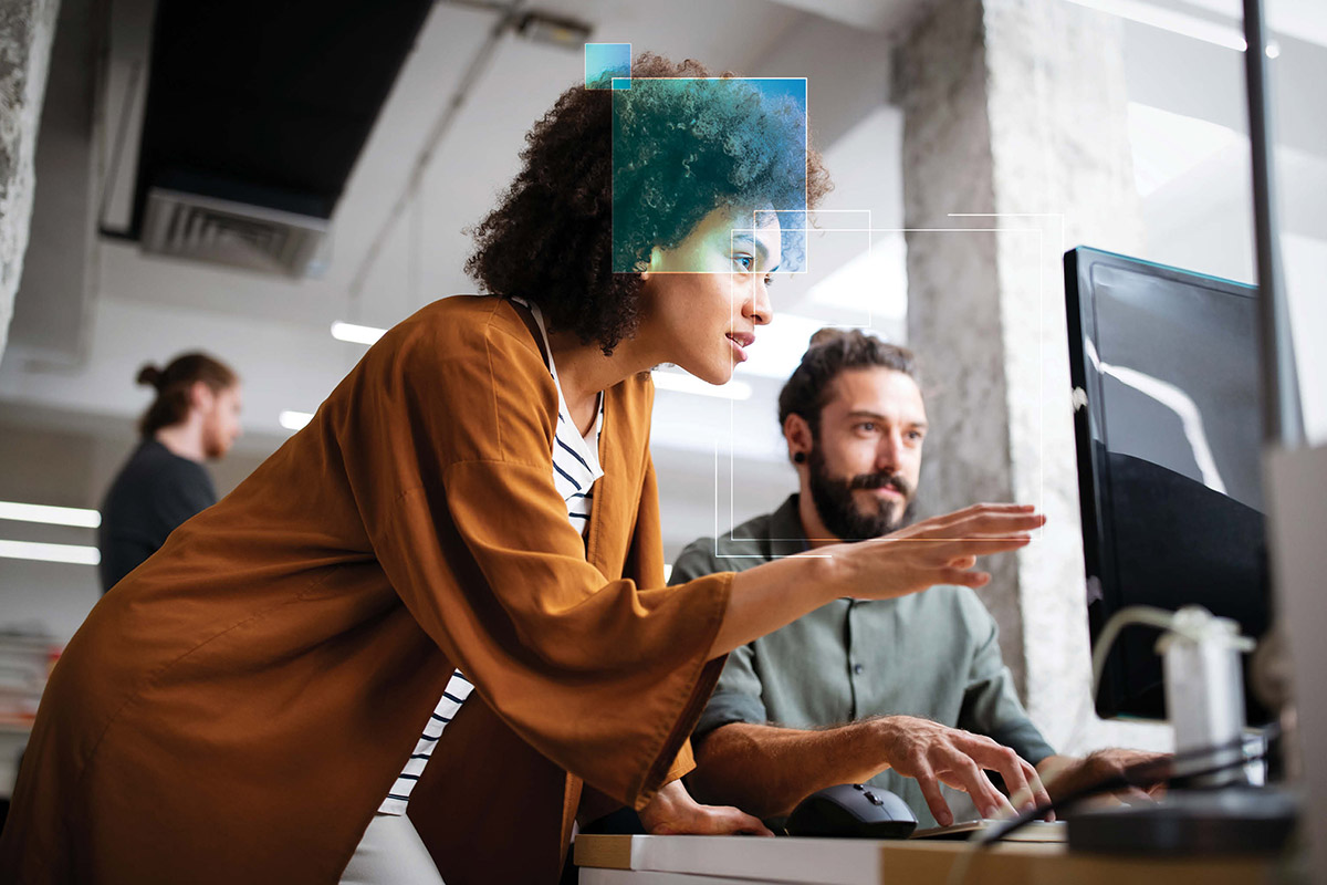 woman helping man secure his computer and breaking silos