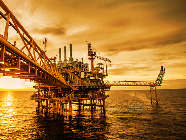 Industrial oil rig at sunset