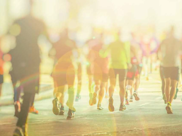 a group of athletes running towards a sunrise during a foundation run.