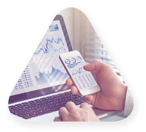 man reviewing analytics on laptop and mobile phone.