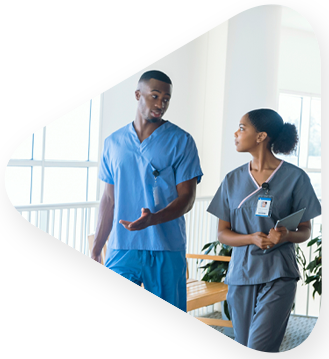 Two healthcare workers discussing completion of an learning solutions collaboration with TEKsystems