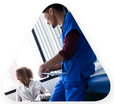 Healthcare worker speaking with young mother and child after completing an learning solutions collaboration with TEKsystems