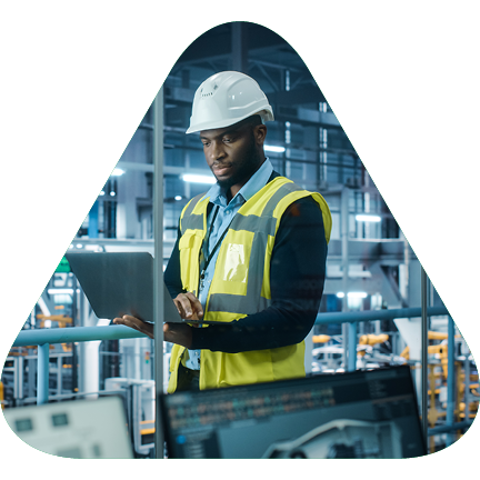 Worker with a hardhat looking at a laptop