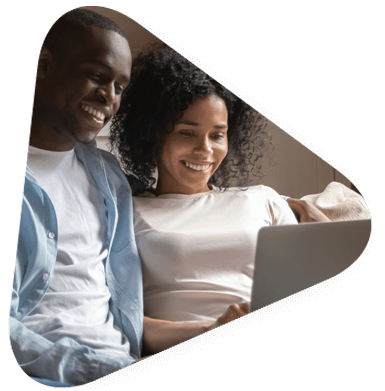 woman and man seated close together viewing labptop together.