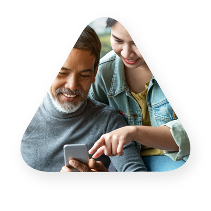 Father, daughter consumers using a mobile phone to review financials