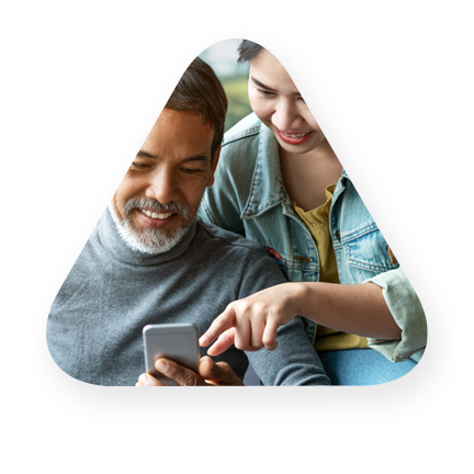 Father, daughter consumers using a mobile phone to review financials 