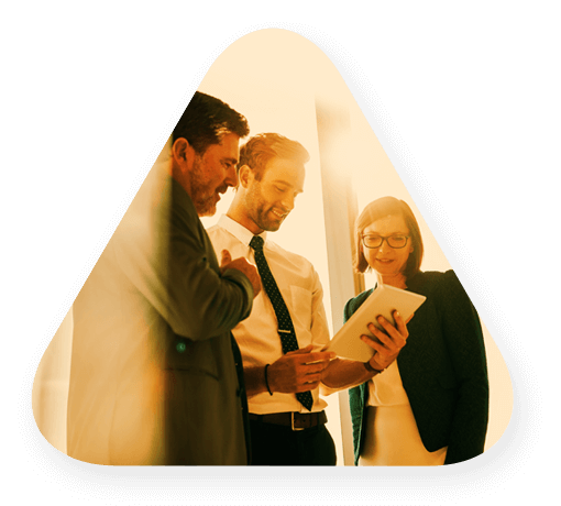 Three people coming together in partnership while looking at a tablet