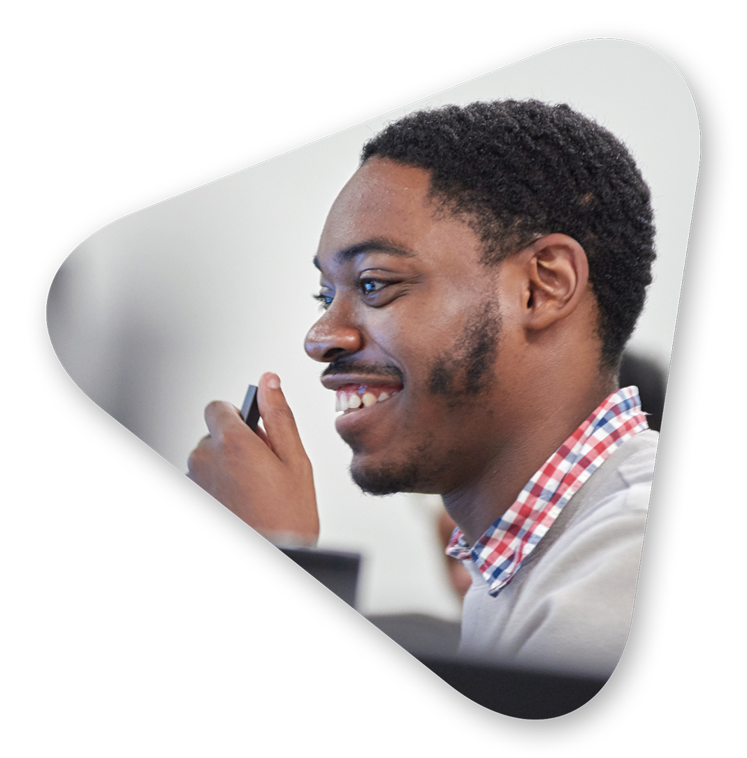 A smiling Per Scholas student