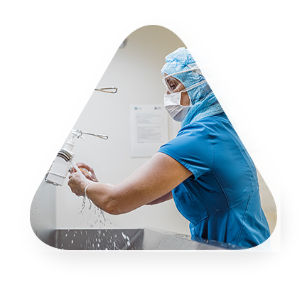 medical professional washing hands in a hospital setting