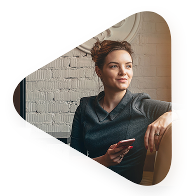 young white woman sitting on couch holder her cellphone