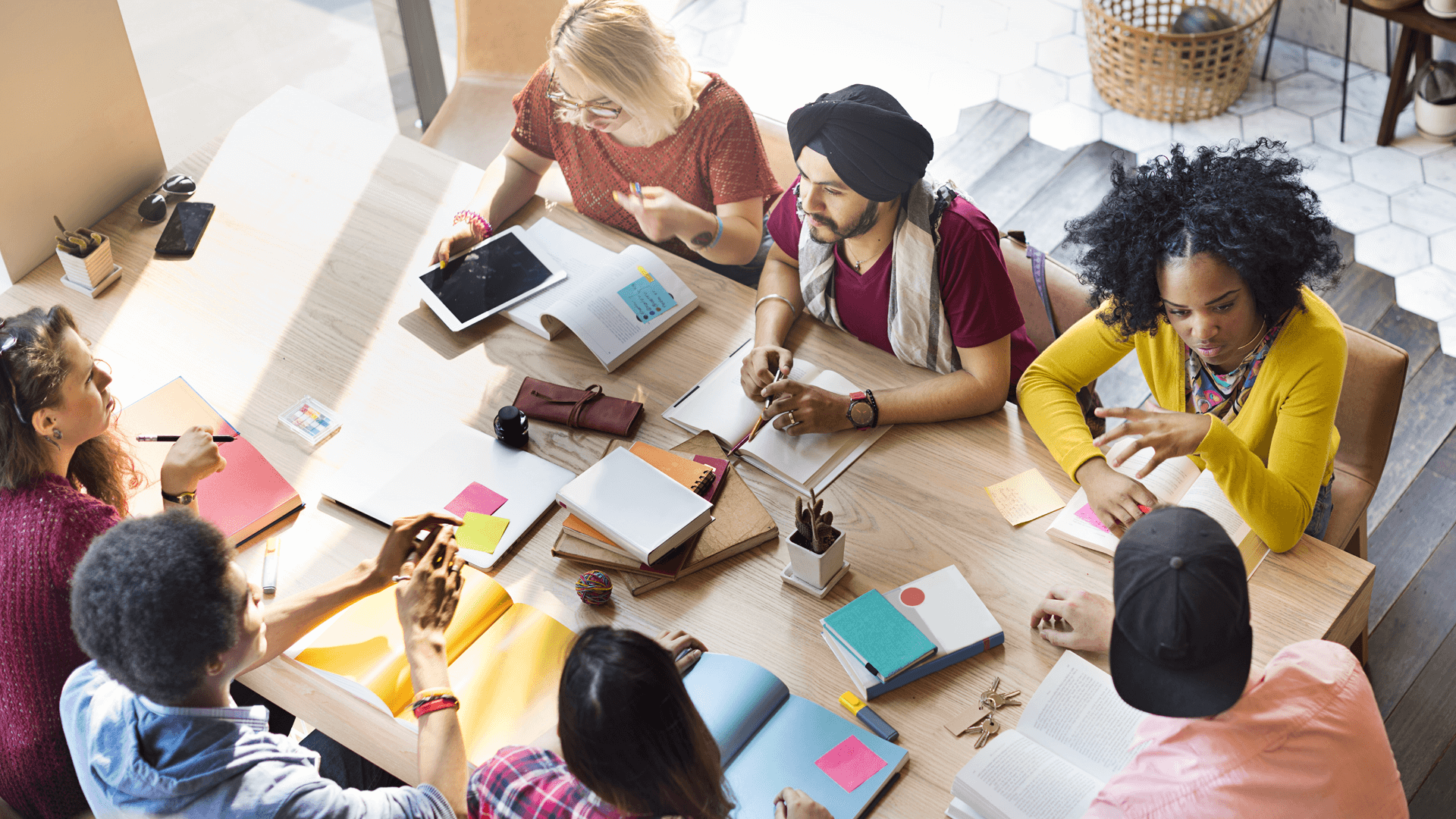 a diverse team of seven sitting at a table