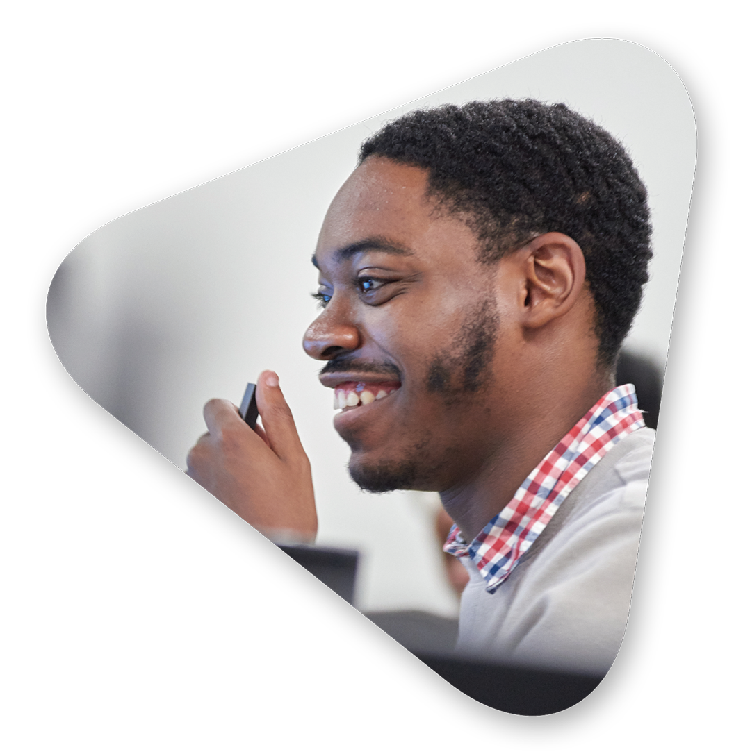 A smiling Per Scholas student