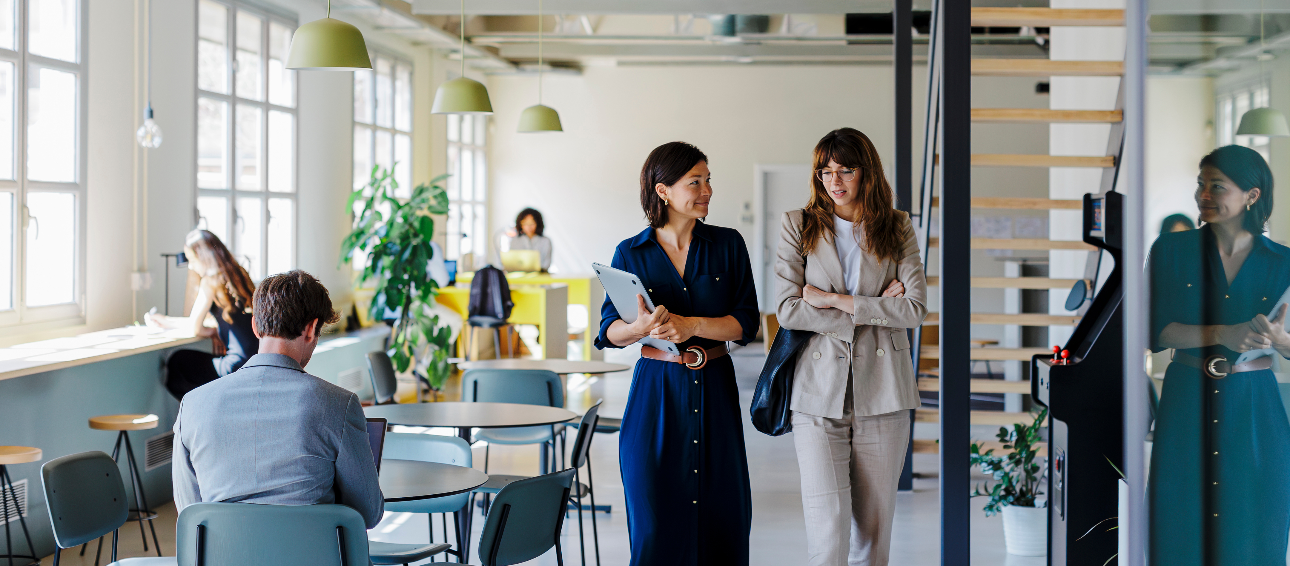 A modern office space with people working and interacting.
