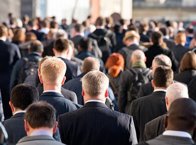walking behind a crowd of business professionals