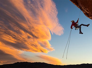 Someone scaling down a cliff