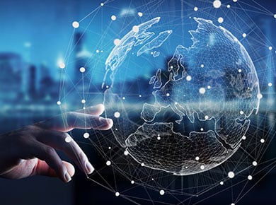 Hand reaching towards holographic globe illustrating IT hiring trends for the city in the background