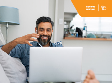 A man sits with his laptop on a video conference discussing IT workforce trends amid COVID-19