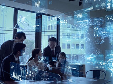 A group of people sit at a conference room table exploring shifts that enable digital transformations projected around them