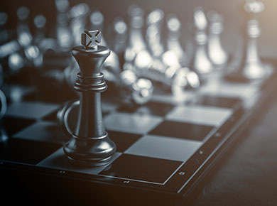 A chessboard with the black king piece in the foreground, alluding to new strategies and ways of working beyond the COVID-19 crisis