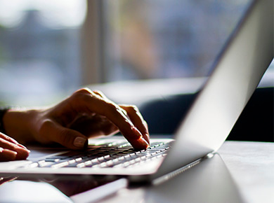 Someone typing on laptop