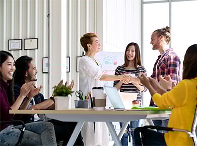 Group of people congratulating someone