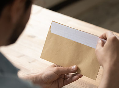 Close up businessman opening envelope with letter
