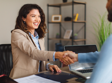 female shaking hands with man in negotiation