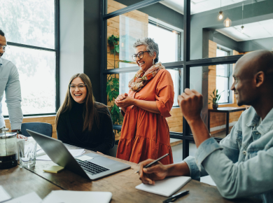 diverse group smiling and working in office setting