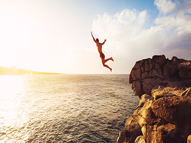 man takes risk jumping into the ocean
