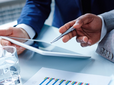 professionals read a list of onboarding activities on a tablet