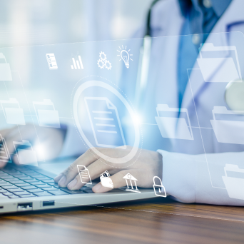 medical professional at laptop working with technology