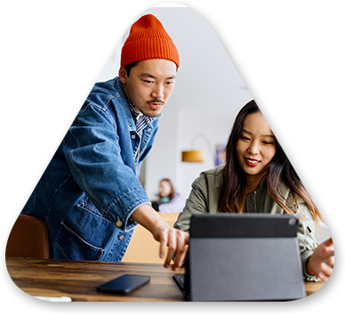 Two people looking at a laptop