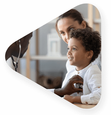 child recieving medical assistance from a healthcareworkerwhile being held by his mother