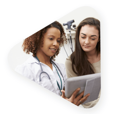 two female healthcare employees reviewing documents on a hospital tablet.
