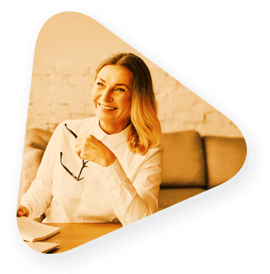 An experienced professional holding a pair of glasses and smiling