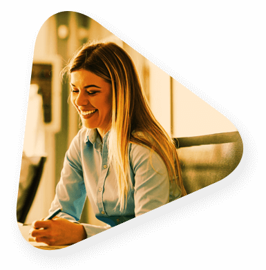 A woman in recruiting and sales writing and smiling