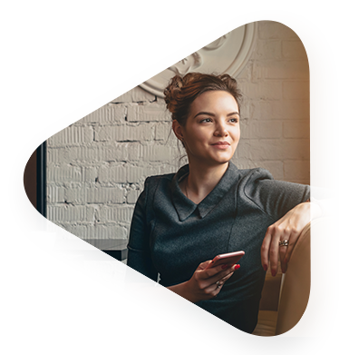 young white woman sitting on couch holder her cellphone