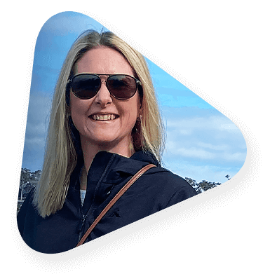 Photo of a smiling woman standing by the water