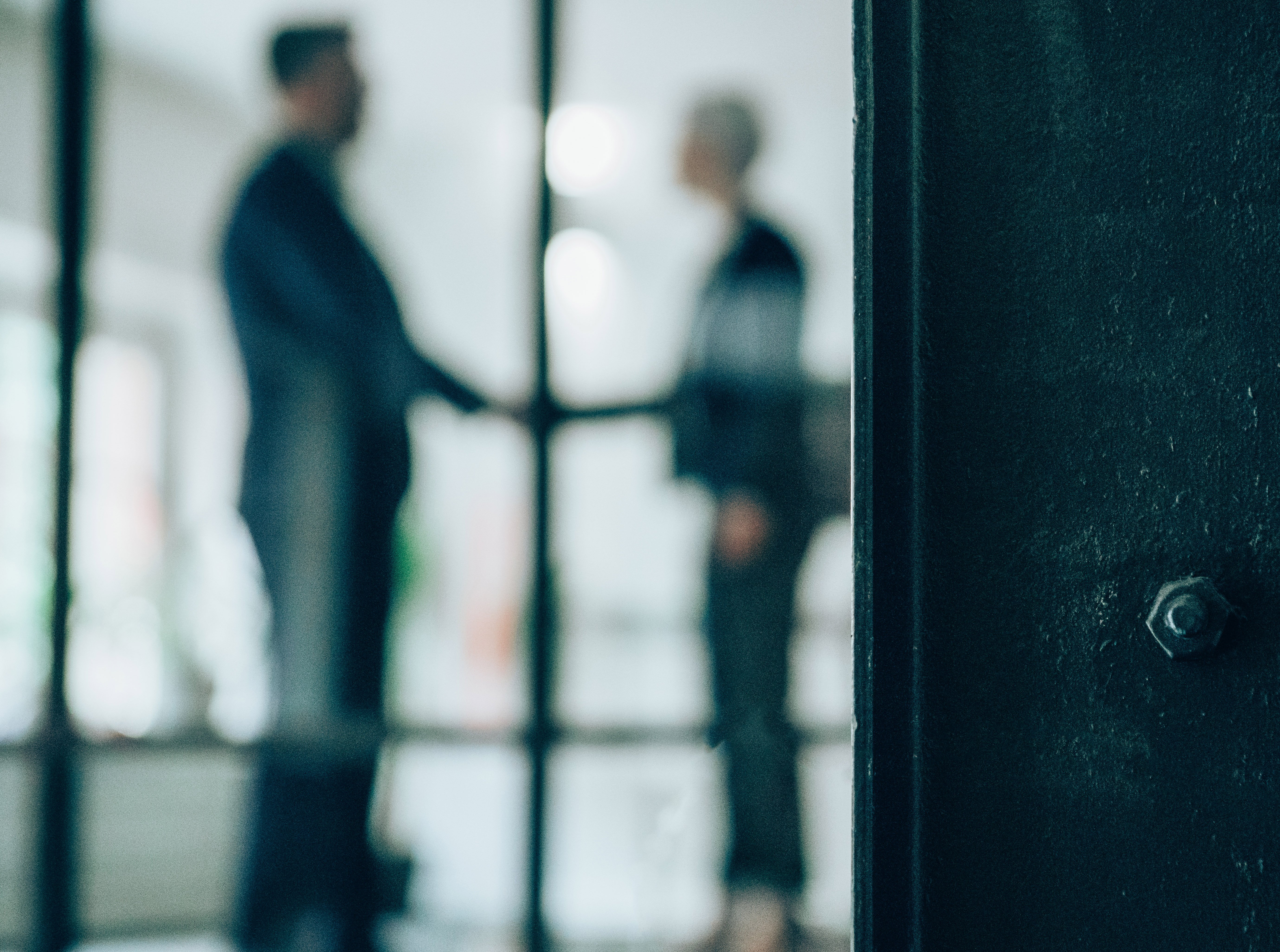 Two people shaking hands in the office.
