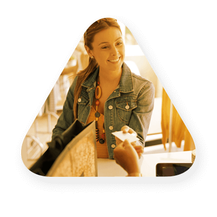 A female who is handing a cashier a credit card