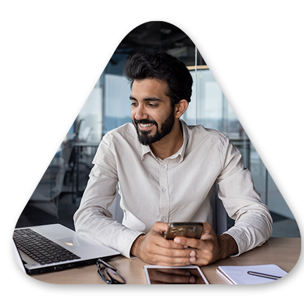 Male looking at computer and smart phone